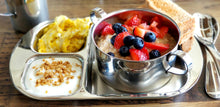 Load image into Gallery viewer, Oatmeal breakfast is served inside a kids tainless steel bowl that is placed on top of a stainless steel kids divided tray. In the smaller cavities are yogurt and egg. 
