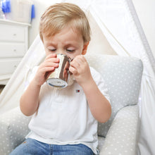 Load image into Gallery viewer, a toddler boy is drinking from a stainless steel cup with handle.
